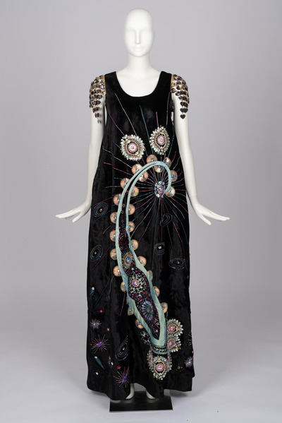 Full-length dark blue velour dress adorned with swirling sequins of various colors.