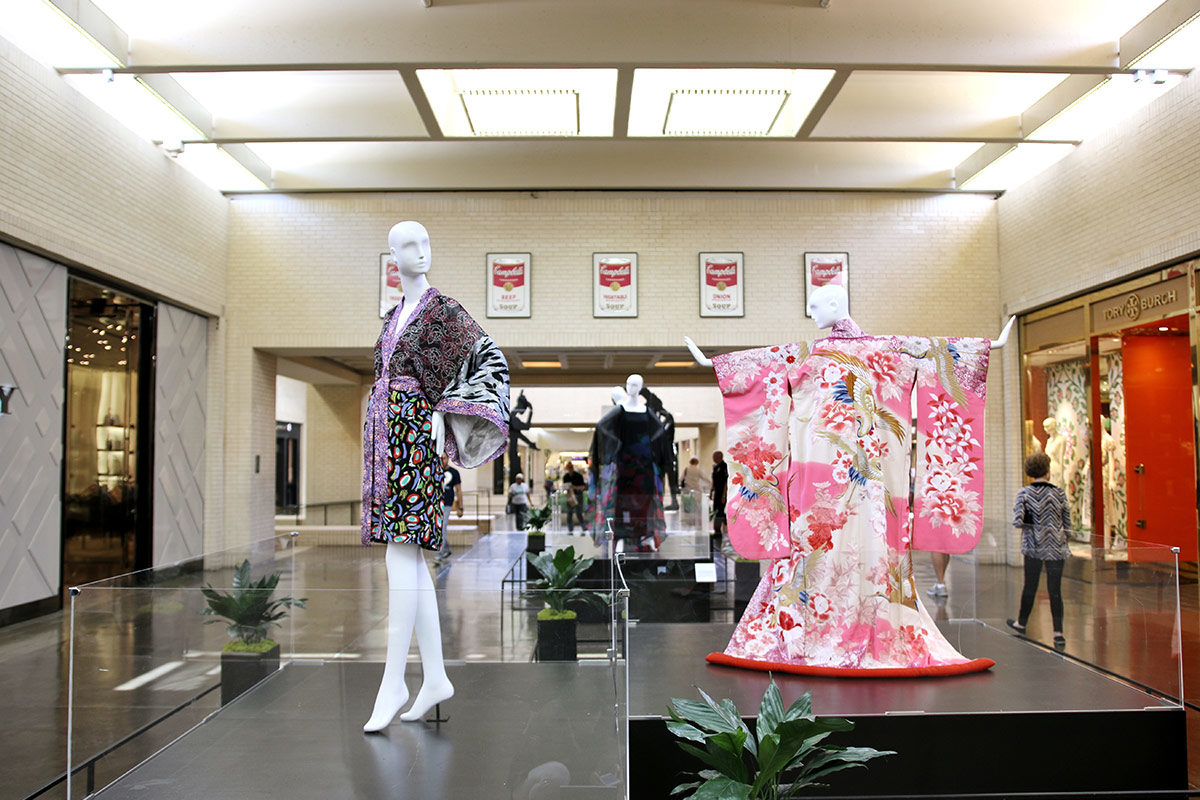 Coridor with platforms showcasing kimono-style garments on mannequins